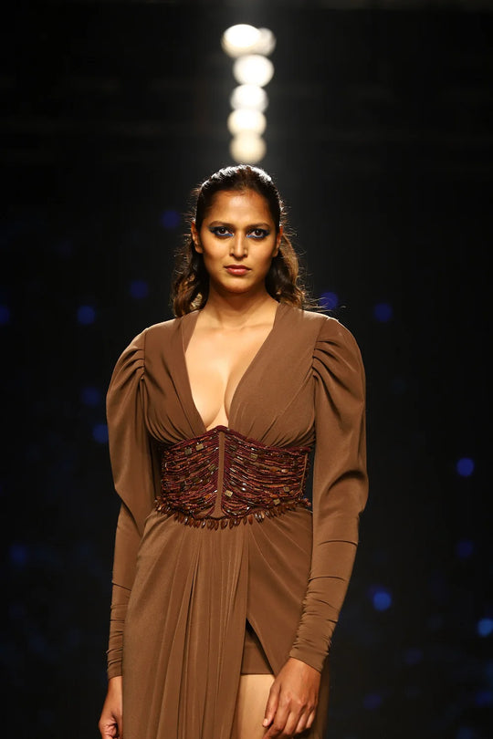 Dark tan couture dress with structured waist detailing and long sleeves