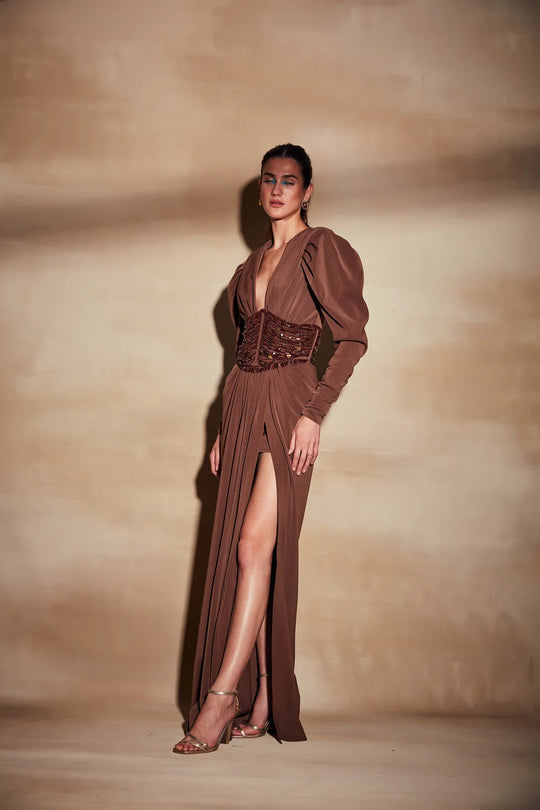 Dark tan designer gown with sculpted bodice and flowing silhouette